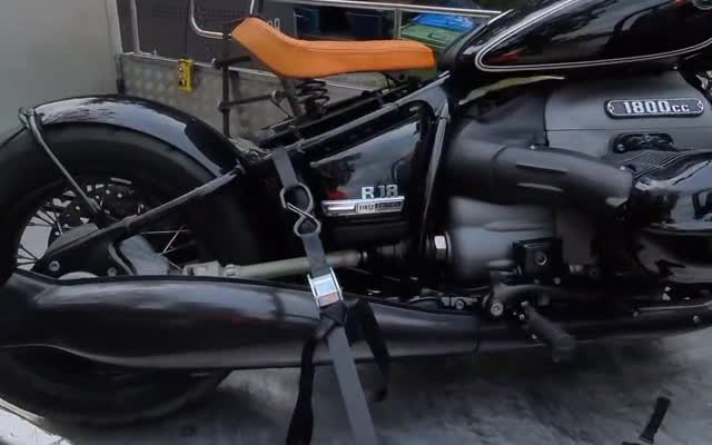 BMW R18 ratchet-strapped to the flatbed, strap over the frame